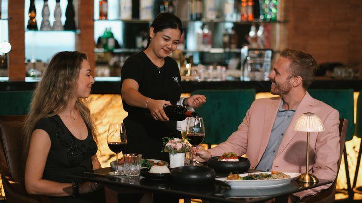 A couple being served at a modern steakhouse