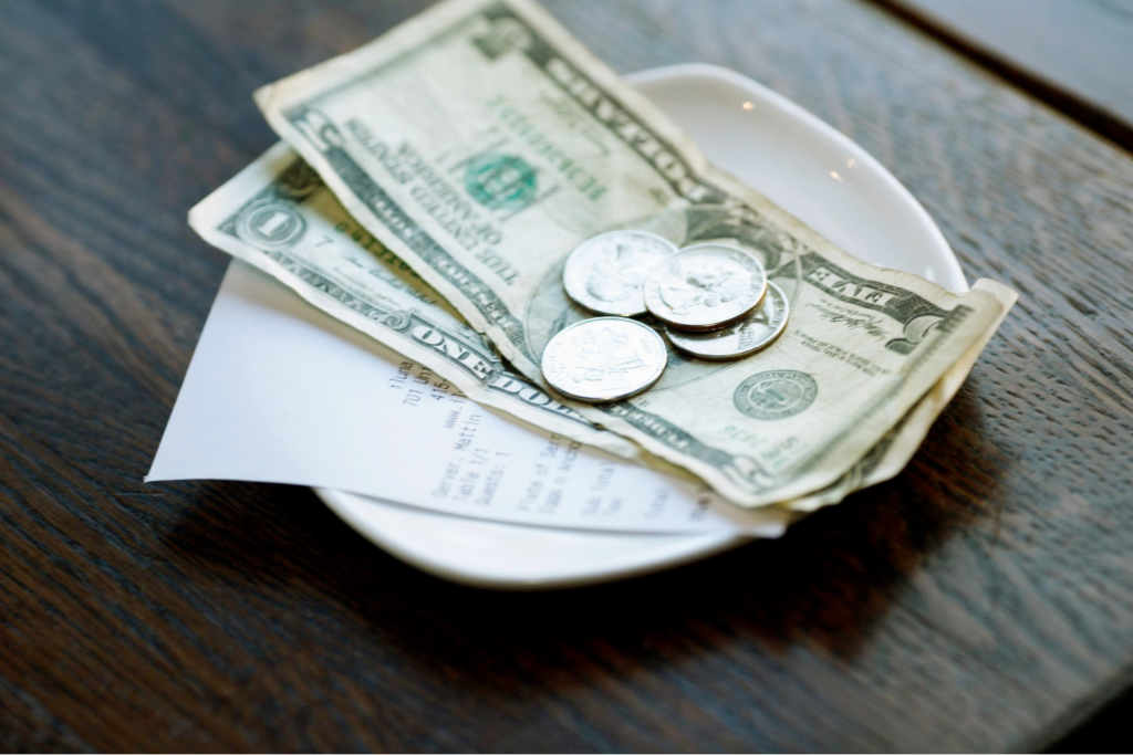 Notes and coins on a tipping plate