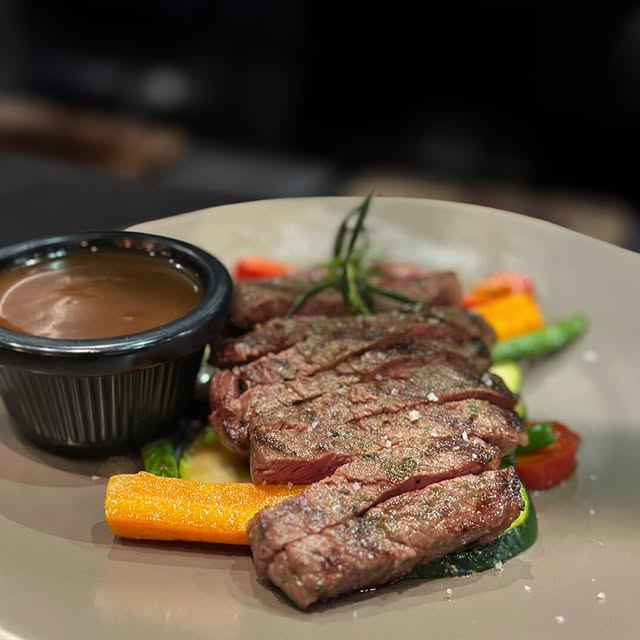 Steak, vegetables and gravy from The Butcher's Club Steakhouse
