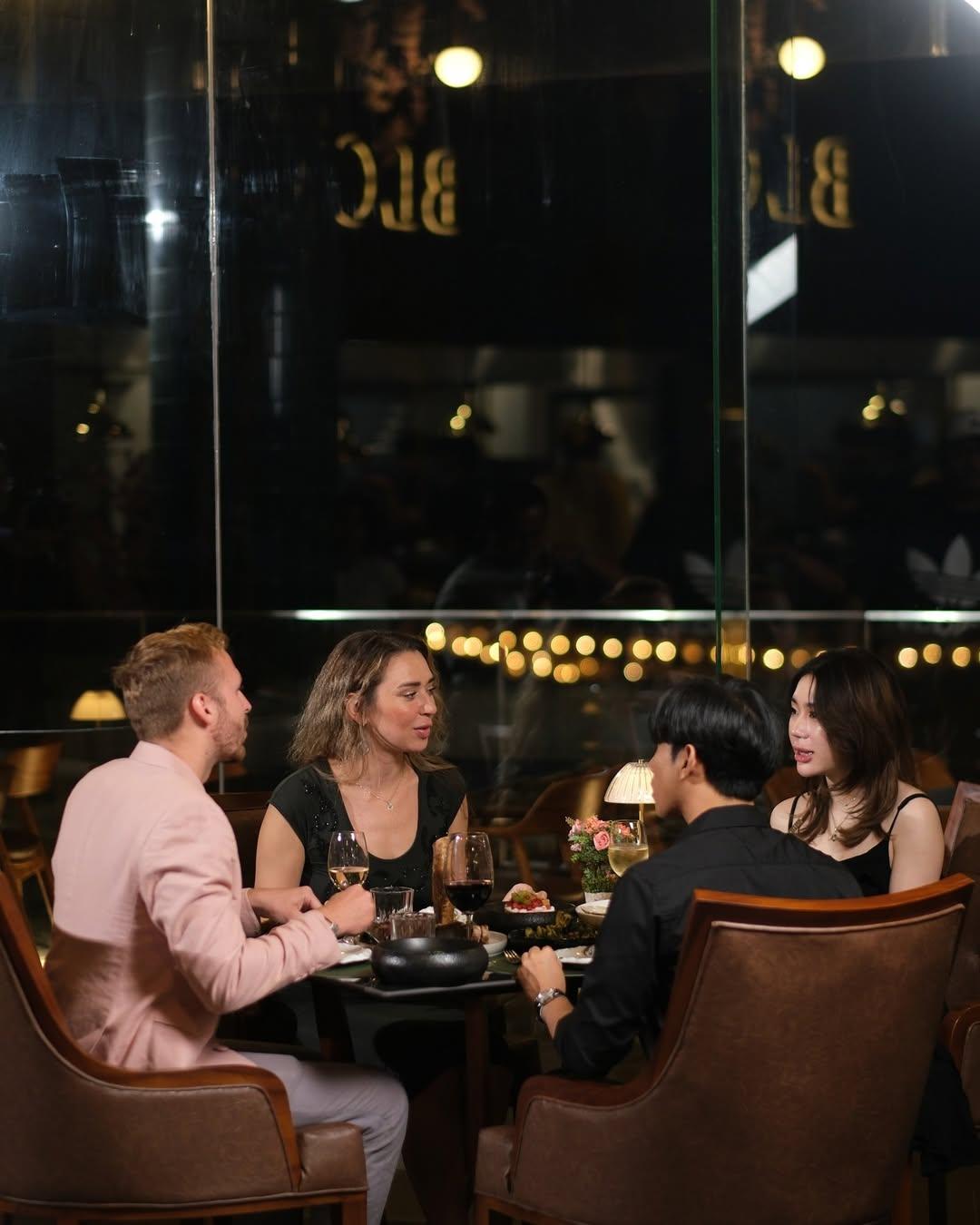 A group of friends dining at a steakhouse