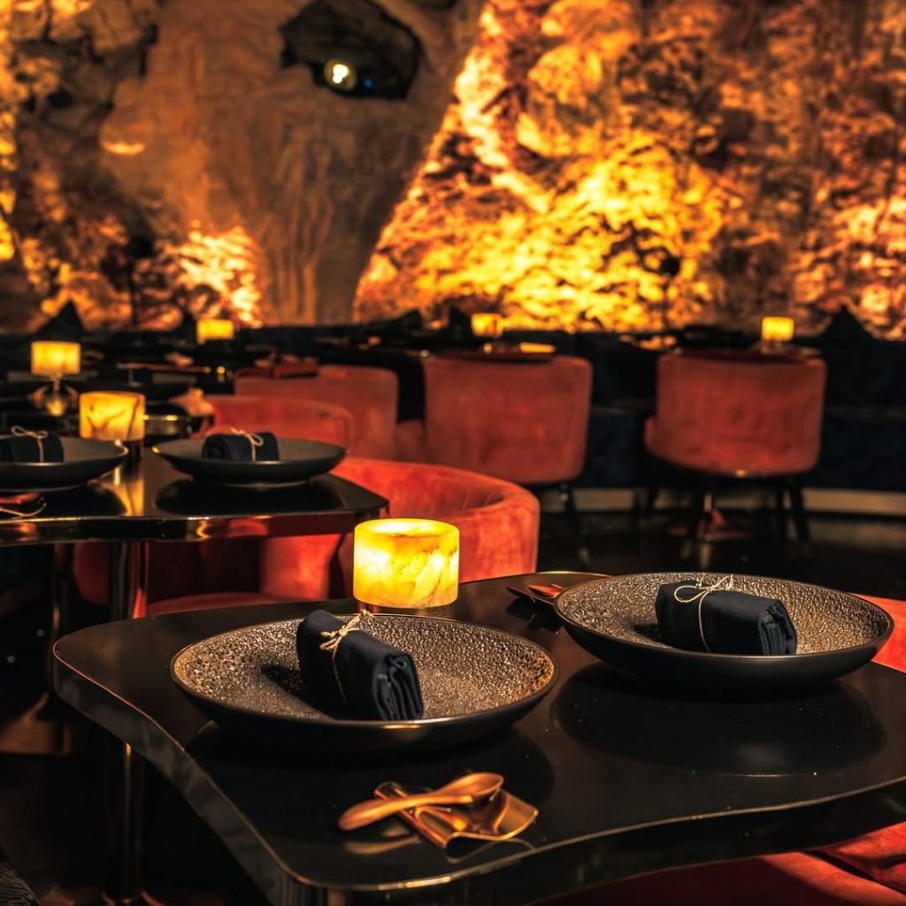 The elegant table settings and underground cave interior at the Cave Bali