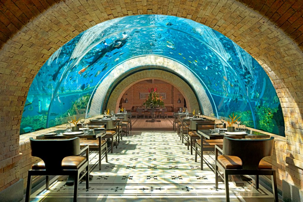 The interior view of Koral Restaurant Bali showing the underwater dining area