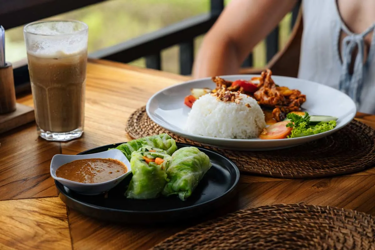 Some simple Balinese rice dishes and a drink sitting on a table