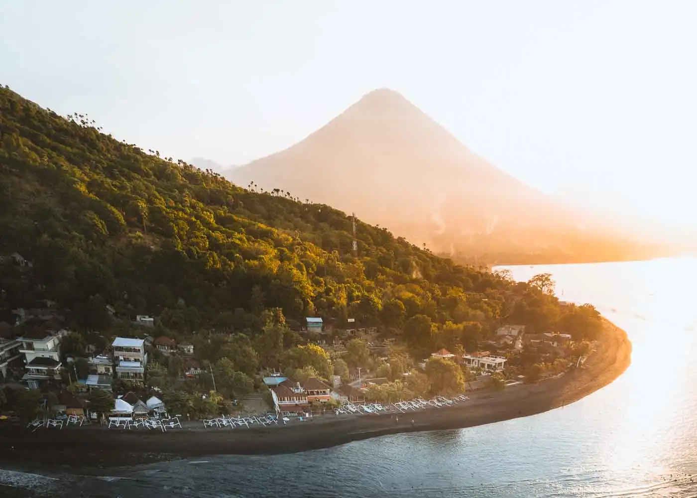 An aerial view of the town of Amed, Bali with mountain in background