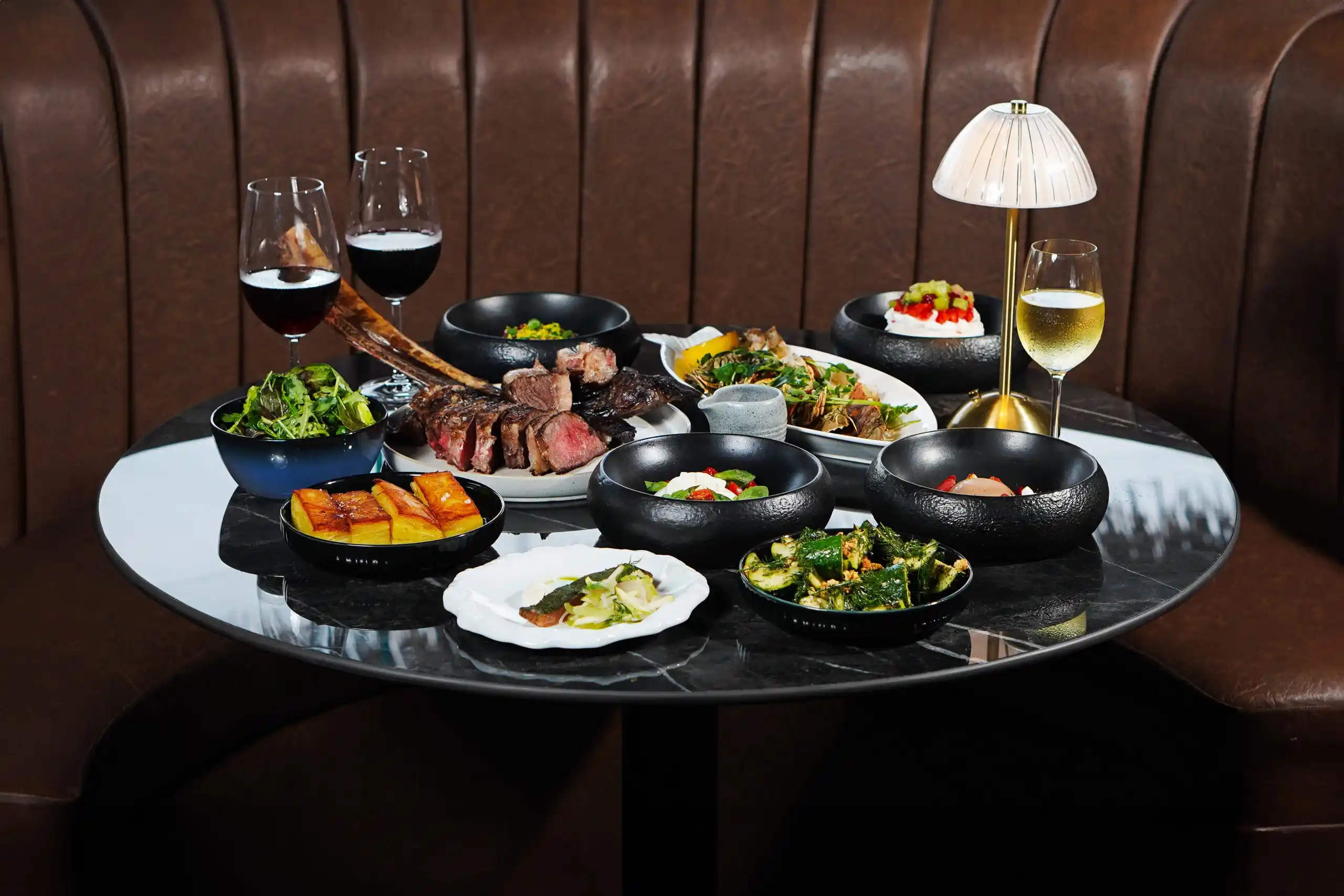 A selection of dishes including seafood and steaks