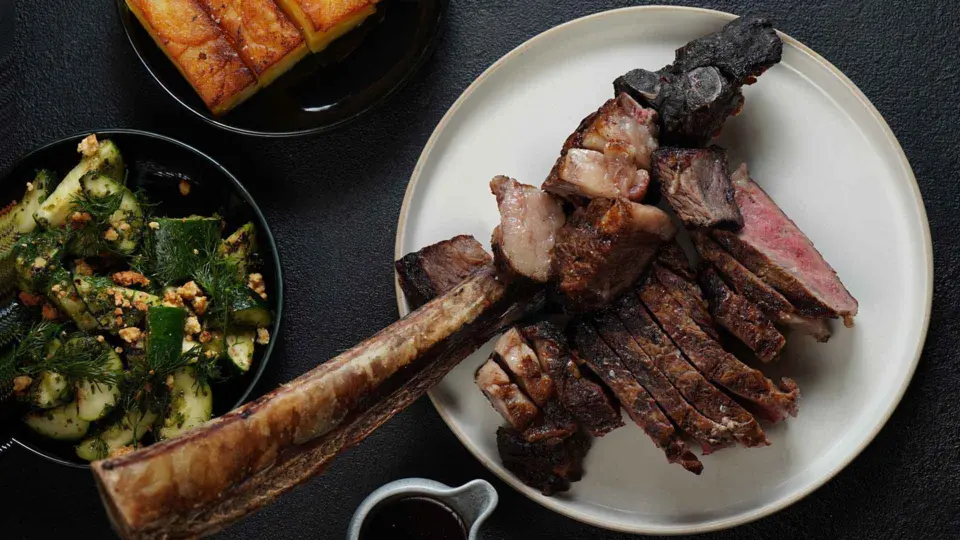 A tomahawk steak with a side salad from Blossom Steakhouse
