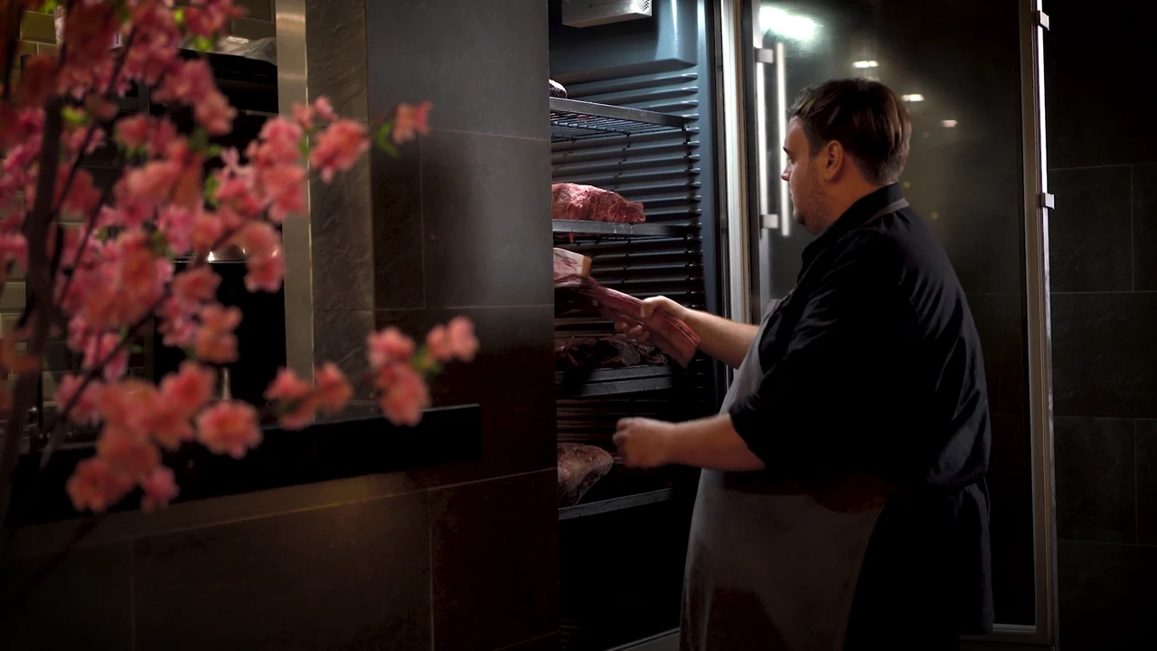 Executive chef Brenton Banner reaching into the fridge for meat